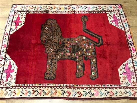 A Gabbeh red ground rug, decorated with a lion 182 x 144cm